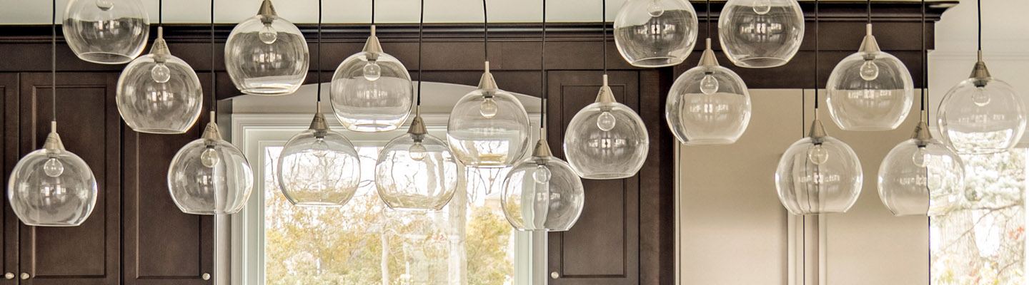 Lights above a center island in an amiano and son kitchen