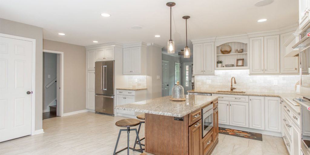 Kitchen with White cabinets and center island in an amiano and son home remodel