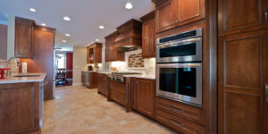 Kitchen with brown cabinets and center island from amiano and son