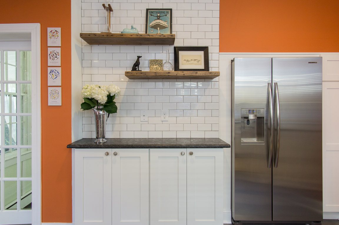Orange kitchen with white cabinets in an amiano and son remodel