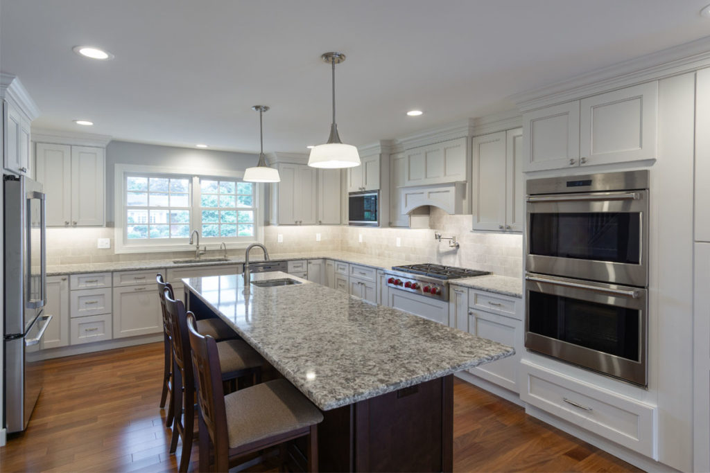 Kitchen with white cabinets and center island from amiano and son builders