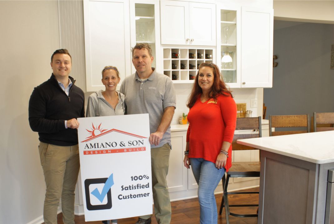 100% satisfied customers standing in their new amiano and son remodel