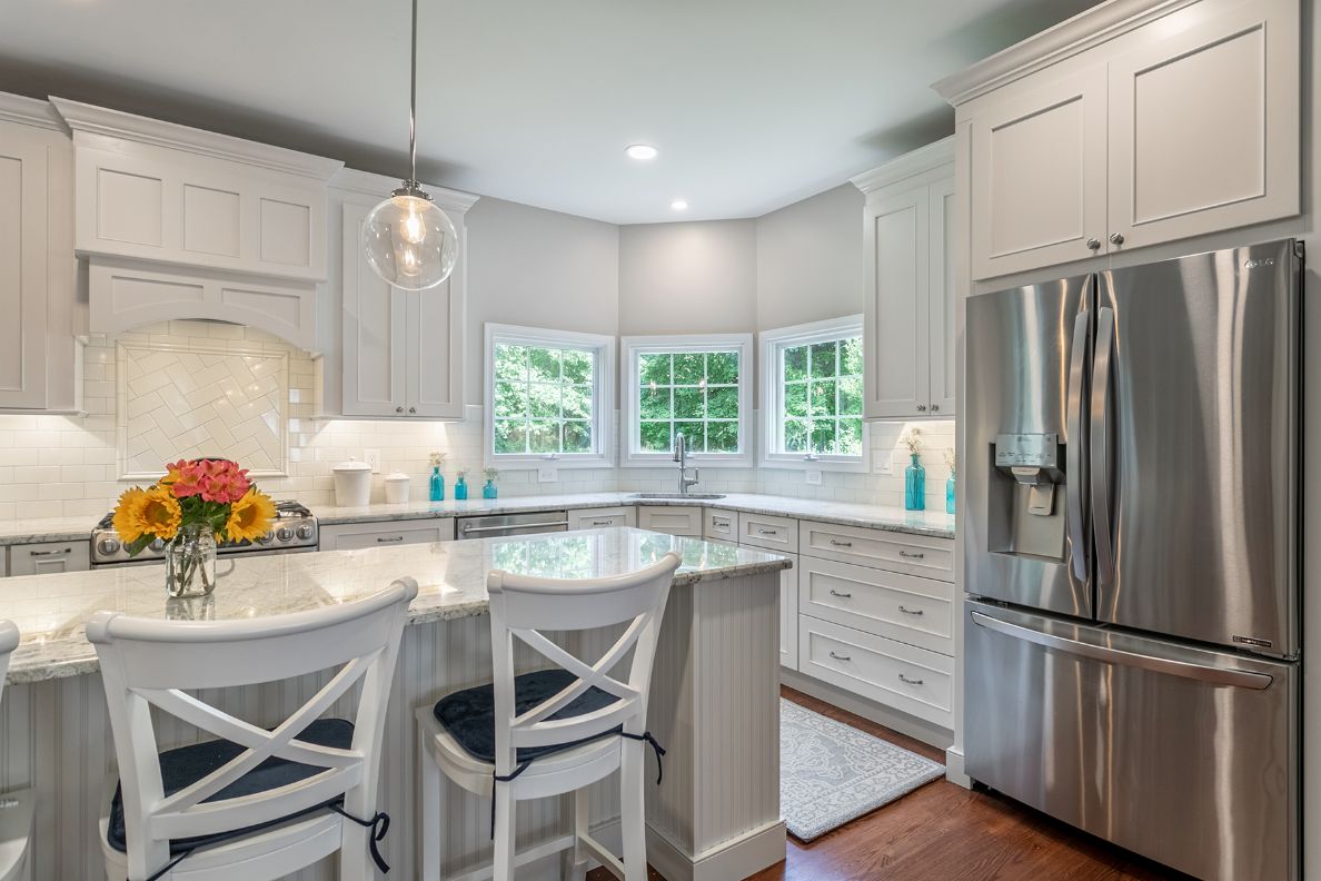 Kitchen with center island and white cabinets from amiano and son