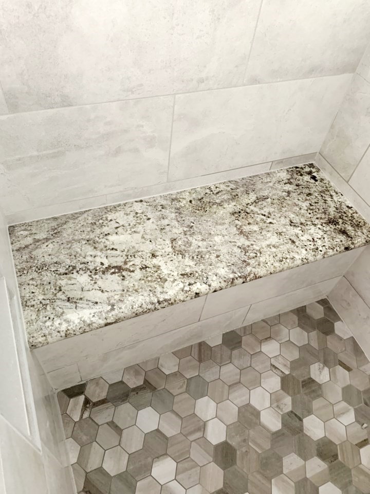 Shower seat in a full bathroom from amiano and son