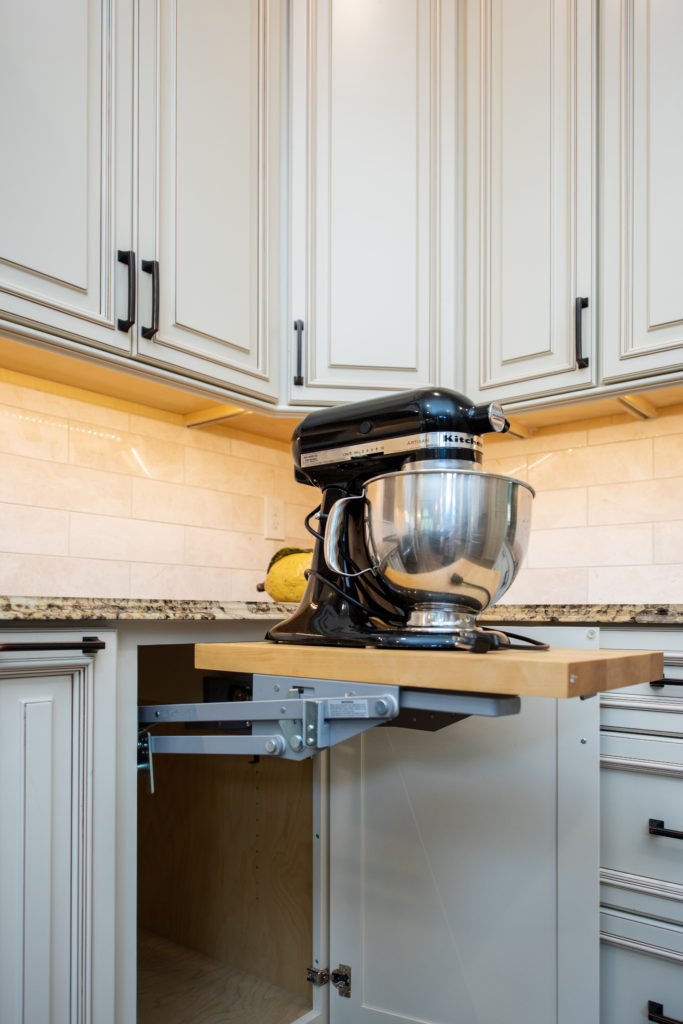 Pull out shelf with Kitchen aid mixer in a kitchen