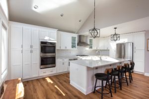 Renovated kitchen with white cabinets and center island from Amiano and son