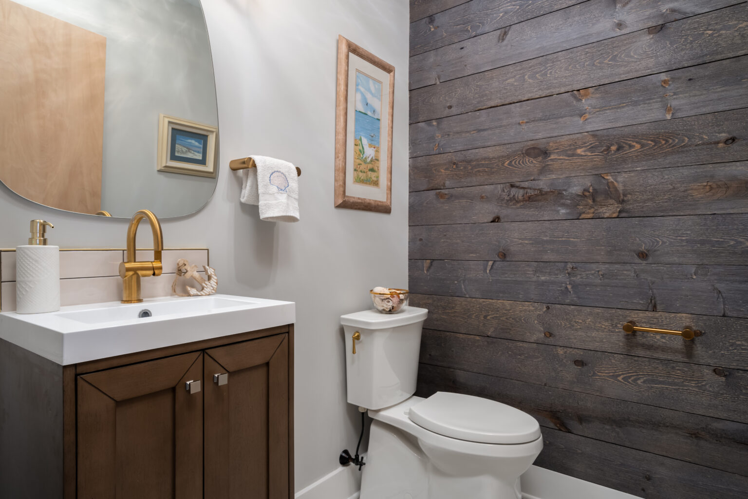 Bathroom with a wood wall and gold accents from amiano and son construction