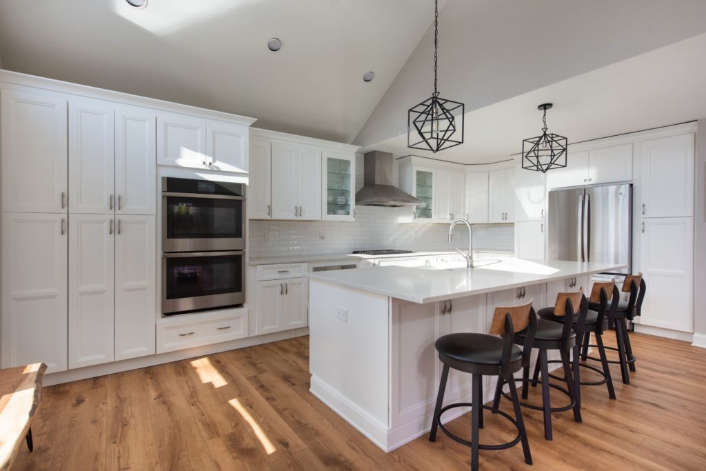 Renovated Kitchen with white cabinets and center island from amiano and son construction
