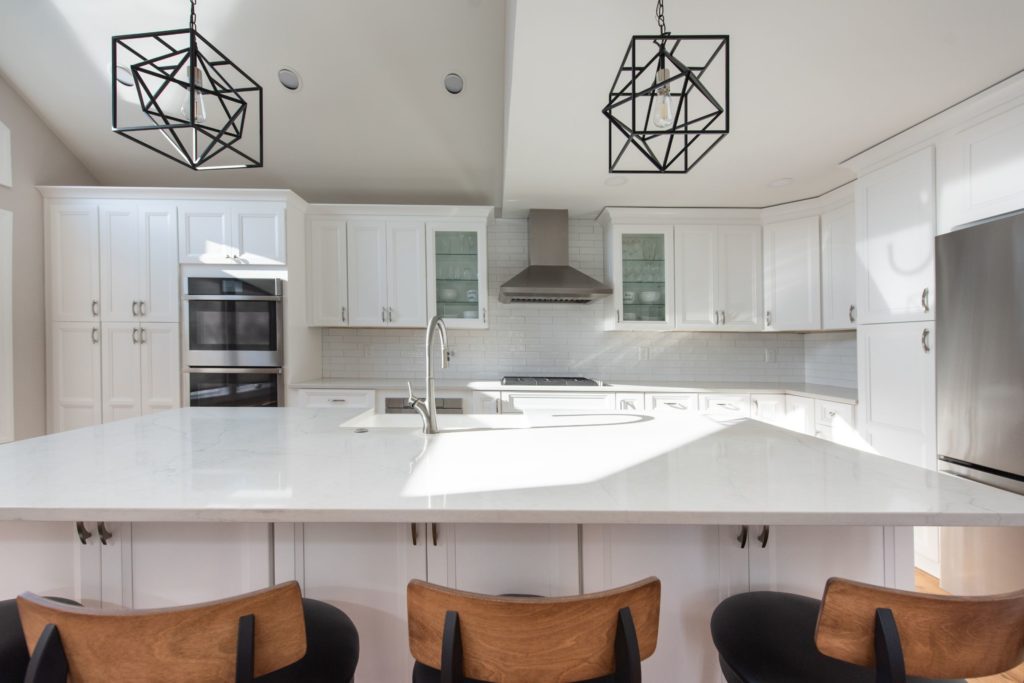 Renovated Kitchen with white cabinets and center island from amiano and son construction