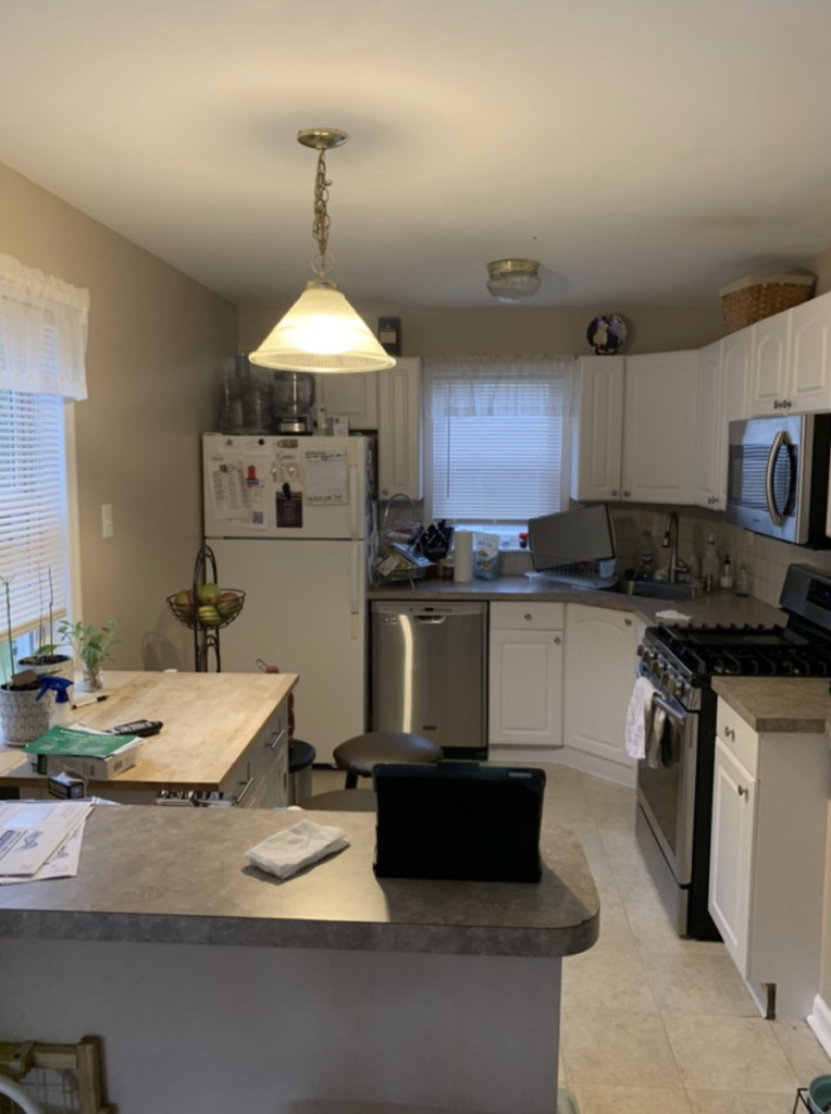 before renovation Kitchen with white cabinets and center island