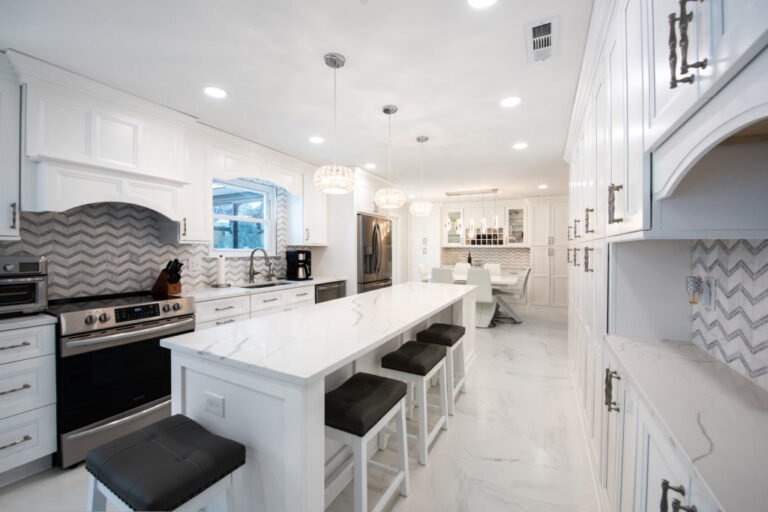Large renovated kitchen with white cabinets and center island from amiano and son