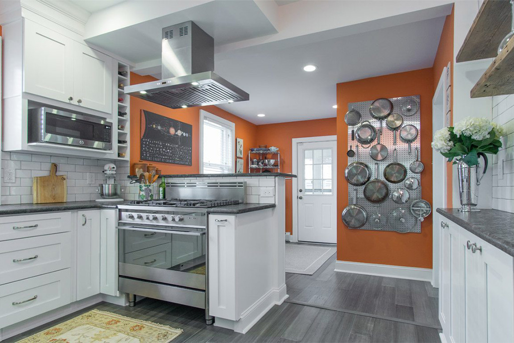 Large renovated kitchen with orange walls from amiano and son