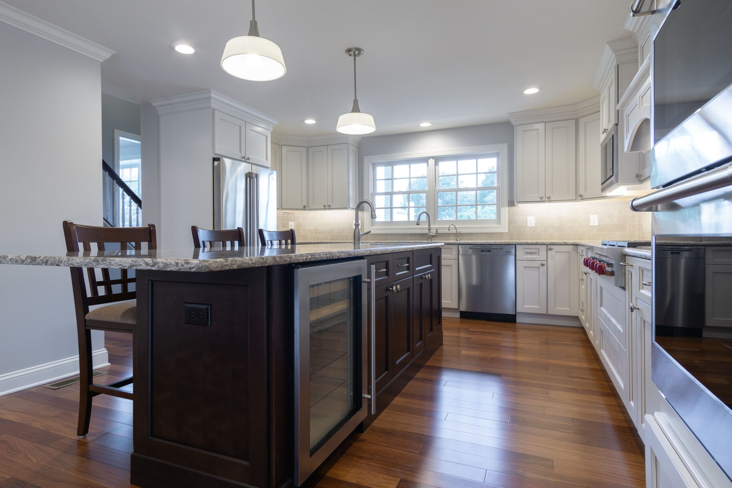 Renovated kitchen with white cabinets and center island from amiano and son