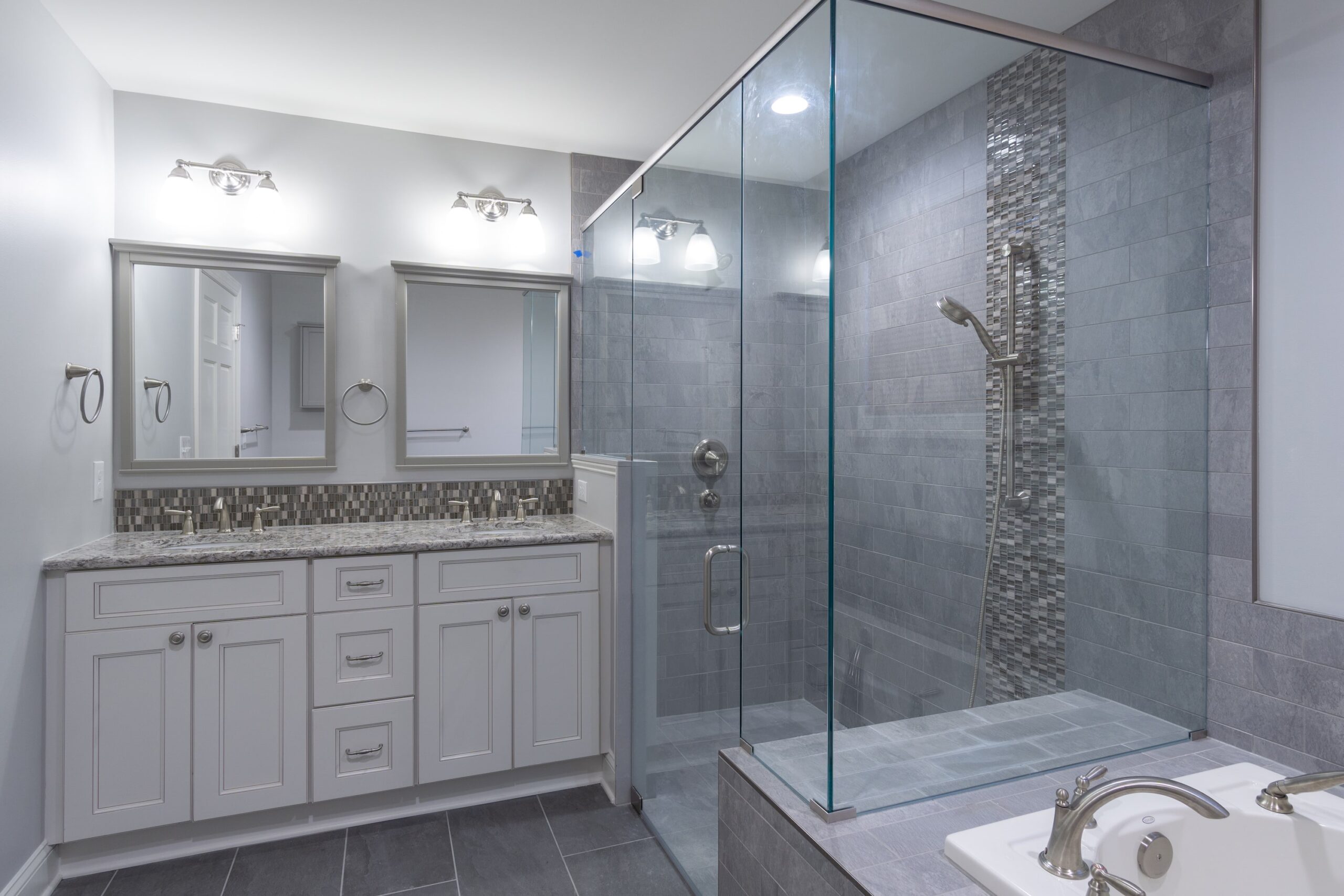 Master bedroom with two sinks and large glass door shower from amiano and son
