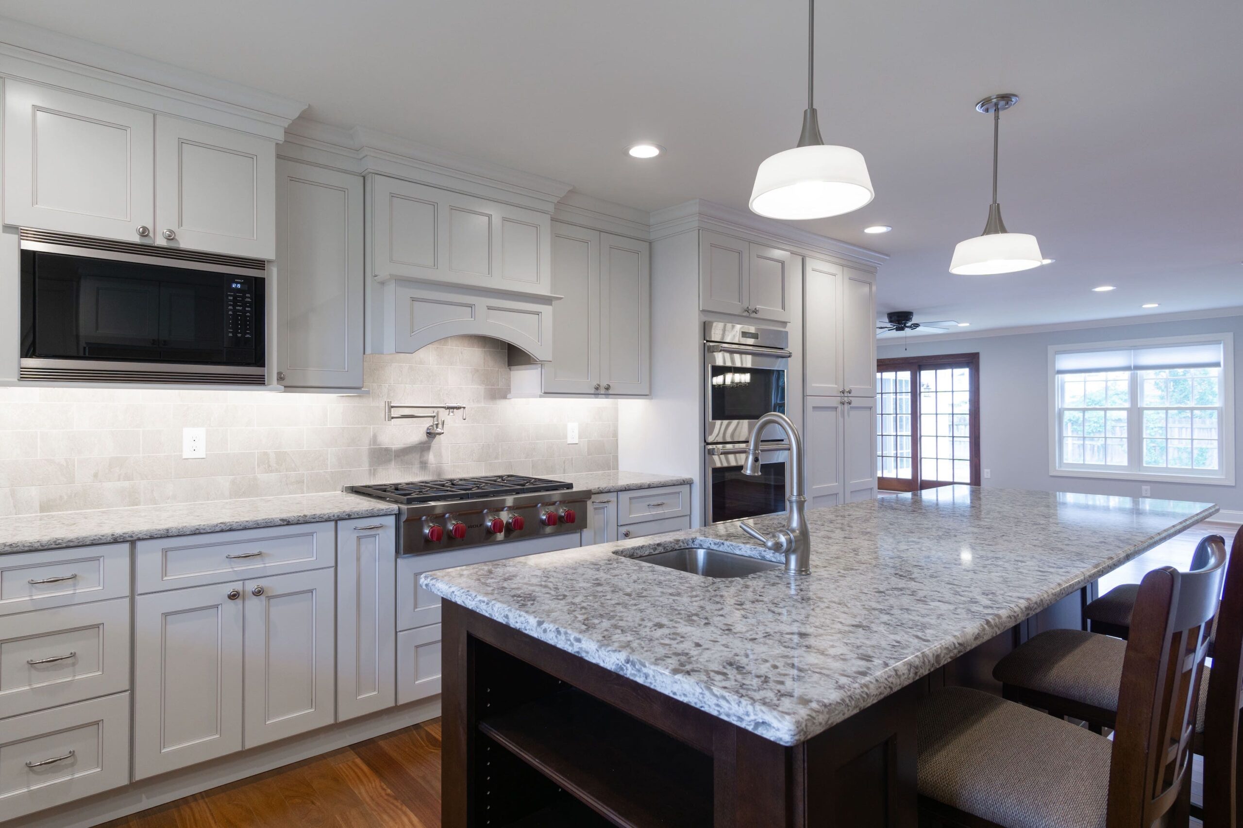 Kitchen with white cabinets and center island from amiano and son