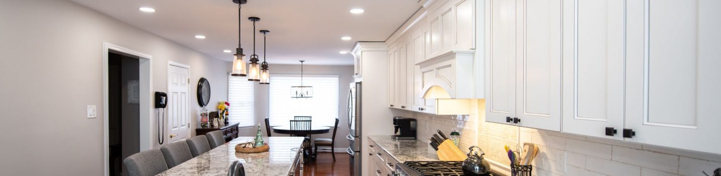 renovated kitchen with white cabinets and center island from amiano and son construction